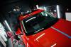 About car detailing concept. man in face mask with orbital polisher in